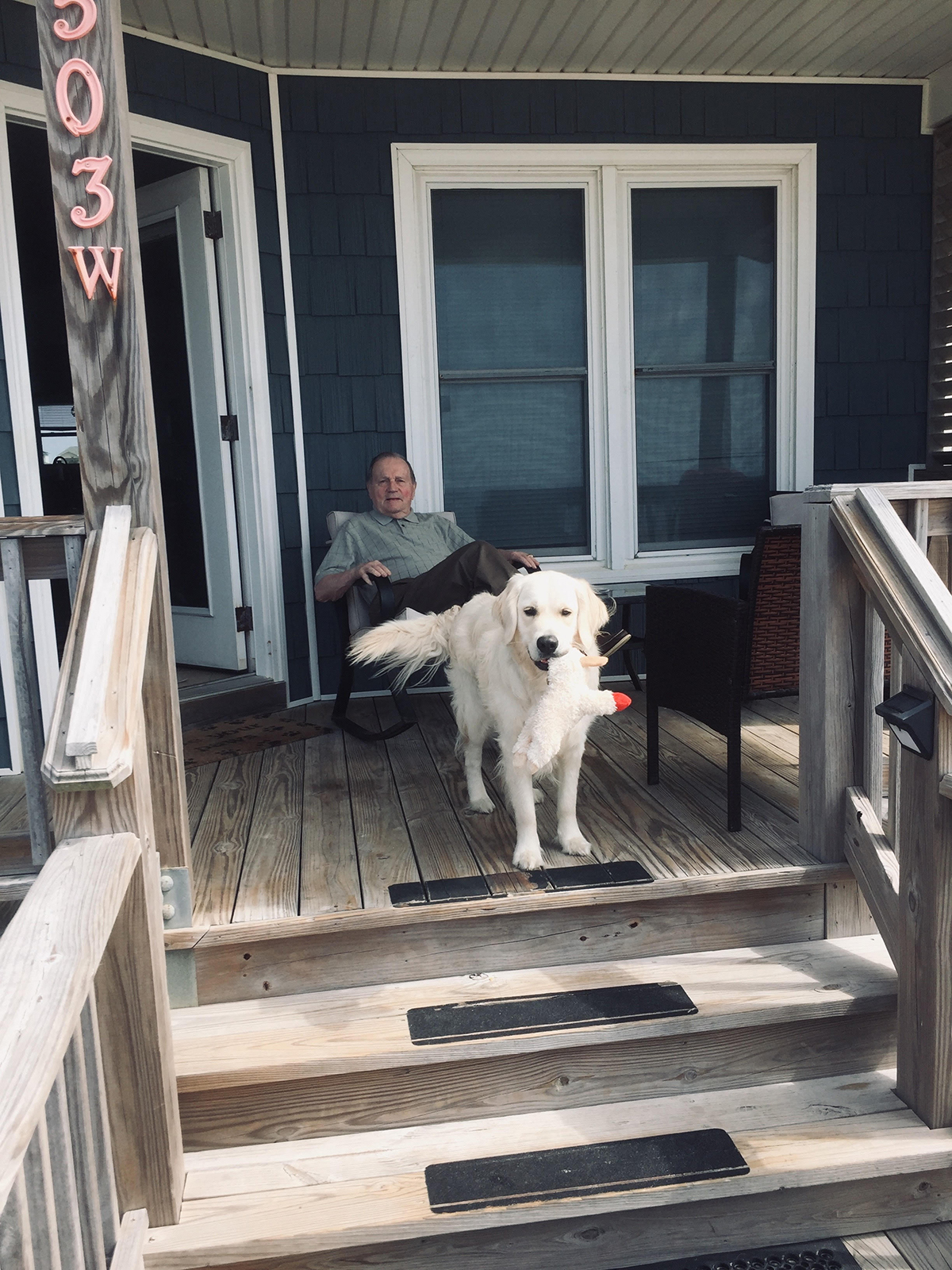 Ted Barrows ’55 on the porch with dog