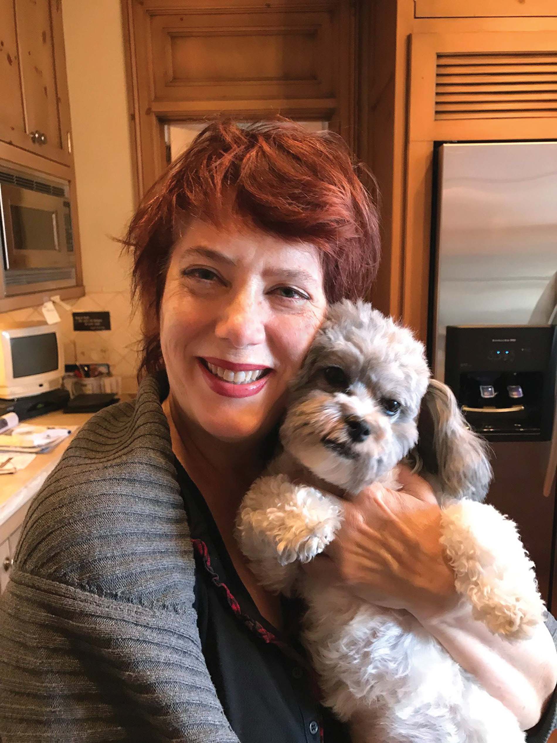 Image of BJ Miller holding her dog