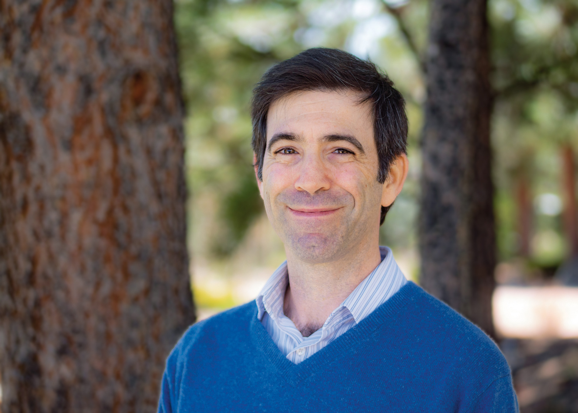 Image of Andrew Schwartz with a tree in the background.