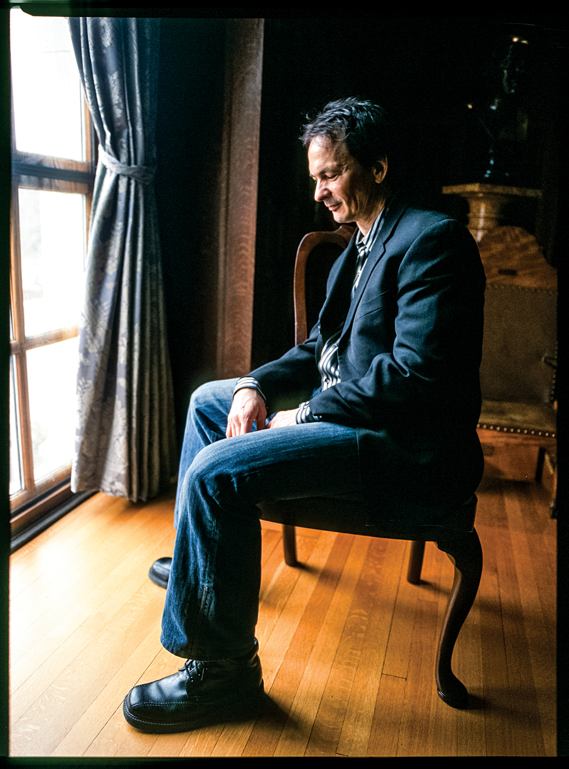 Photograph of Forrest Gander sitting in a chair