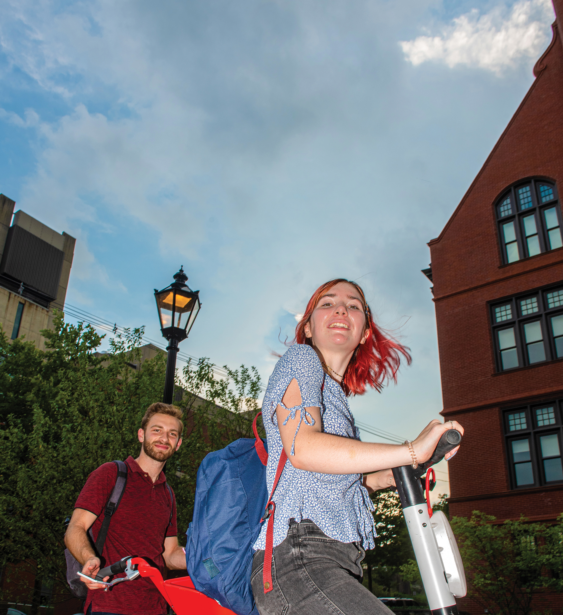 Two students on rental scooter and bike