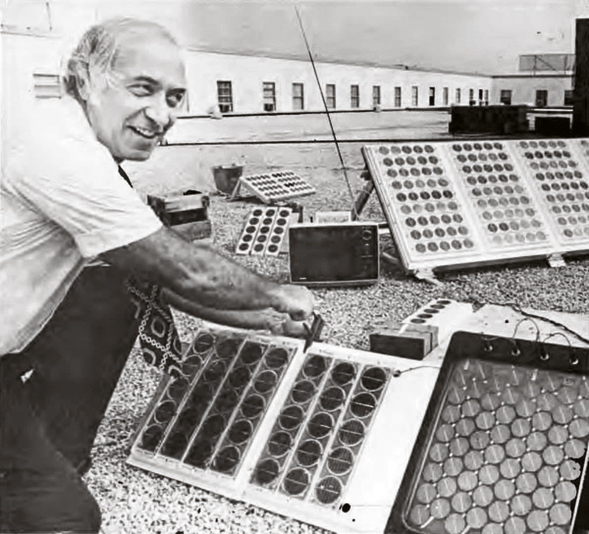 Image of Eliot Berman leaning over solar panels