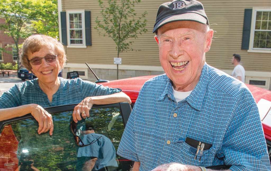 Photo of Bob Traill ’43 and Judy Andrews Green ’68 in front of a car.