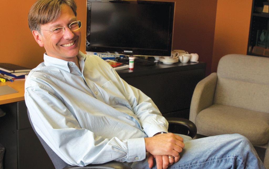 Photograph of Mark Putnam ’86 sitting at his desk