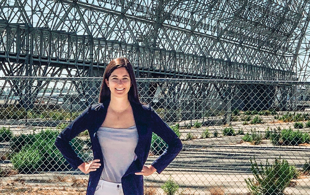 Ariel Deutsch standing outside an old NASA hangar