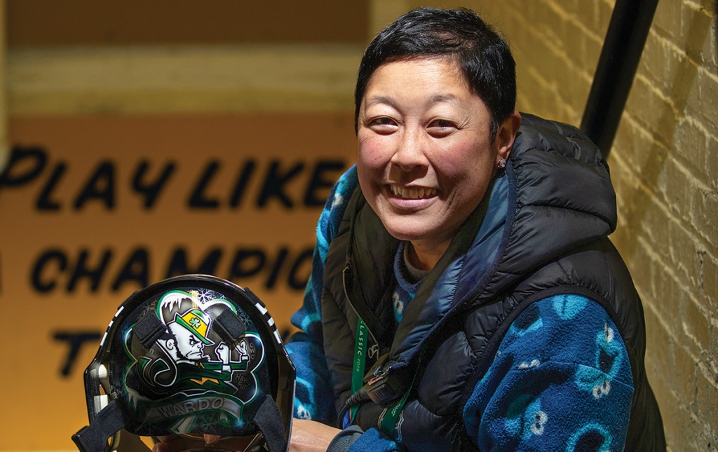 Image of Chie Chie Yard in a stairwell holding a hockey helmet