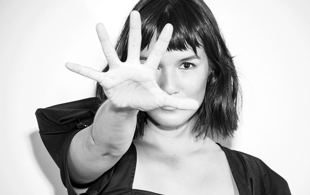 Image of Zoë Chao with her outstretch hand to the camera