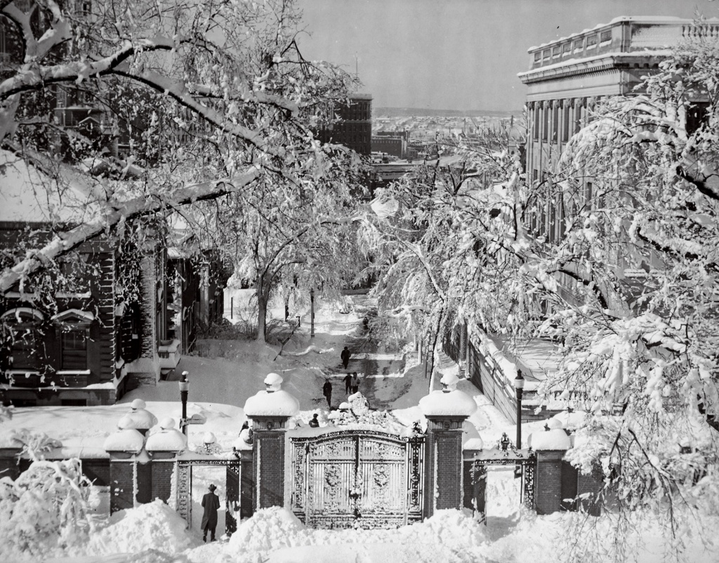 Image of Brown University's Van Wickle gates in the snow in the early-20th century, looking down College Hill.
