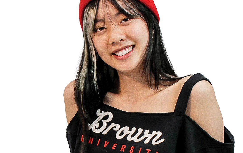 Image of a Brown student wearing a repurposed Brown sweatshirt by Glore Lee ’24