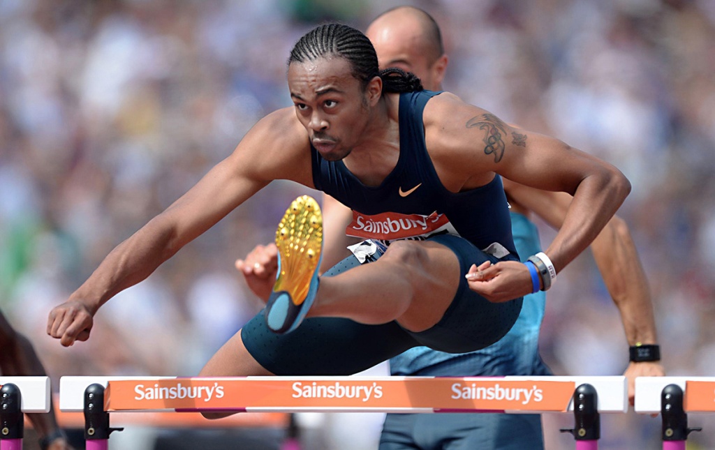 Image of Aries Merritt clearing a hurdle in 2013.