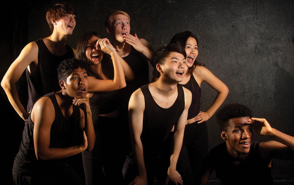 Image of Brown's Gendo Taiko club members dressed in black looking off camera to the right. 