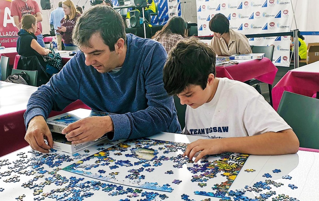 Image of A.J. Jacobs and his son working on a puzzle