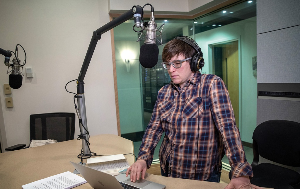 Image of Beth Schwartzapfel in front of a mic with her computer.