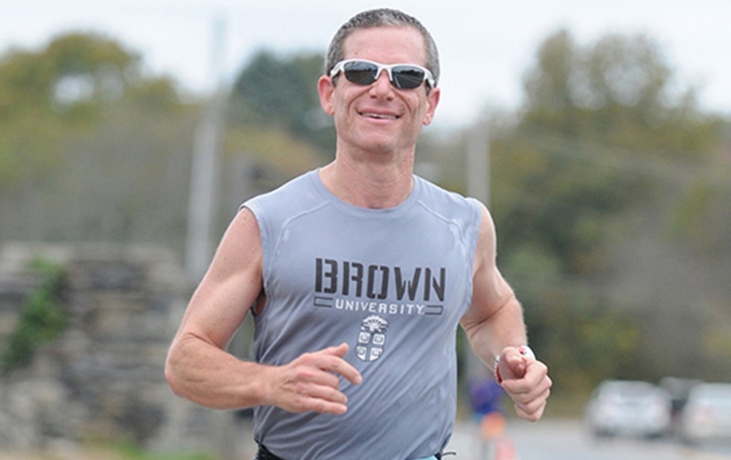 Image of Eliot Ephraim with a Brown t-shirt on running in a race.