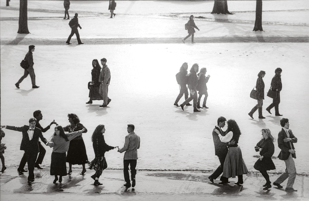 Archival image of students dancing on the snow covered green.