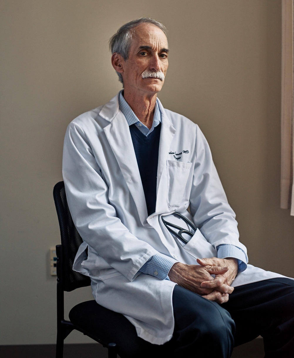 Photograph of Professor Stephen Salloway sitting, wearing a lab coat.