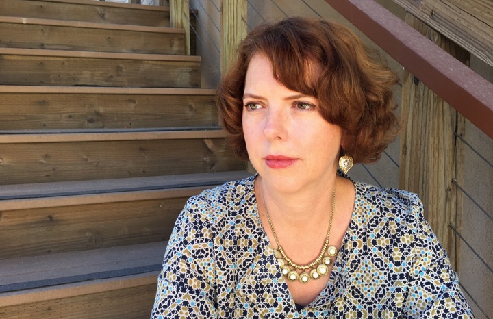 Photo of Susan Valoff sitting on some stairs.