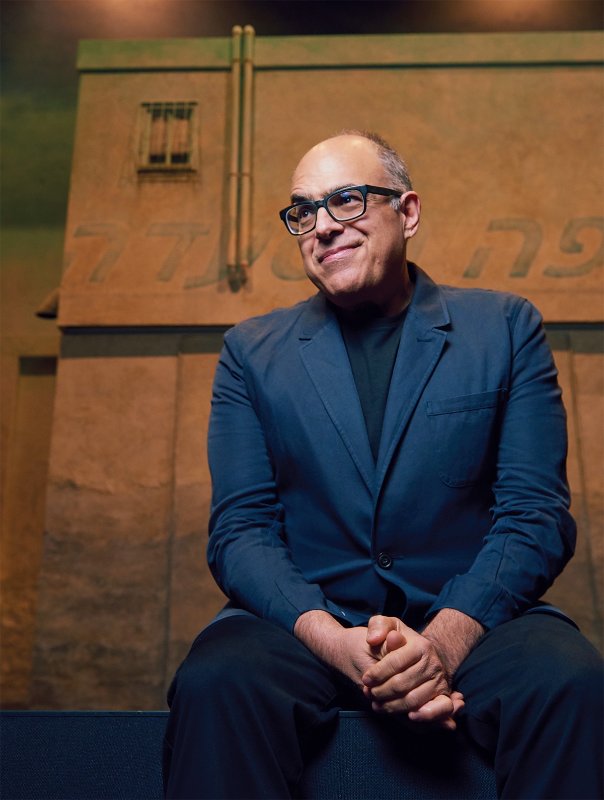 Photograph of David Yazbek in a blue suit.