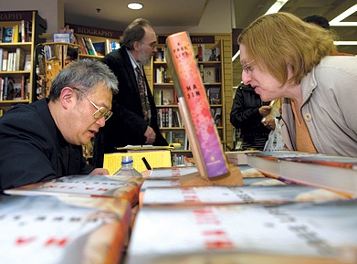 Photo of Ha Jin greeting guests.