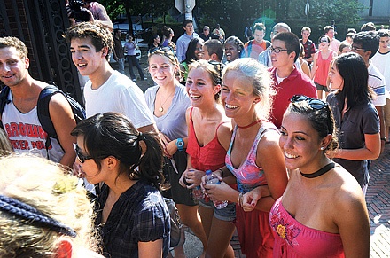 Photo of students walking and smiling.