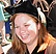 Photo of a woman smiling in a cap and gown.