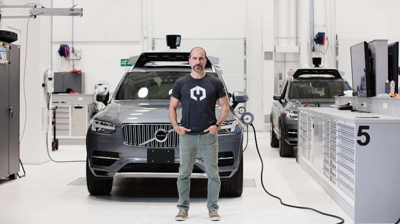 Photo of Dara Khosrowshahi in front of a self-driving car