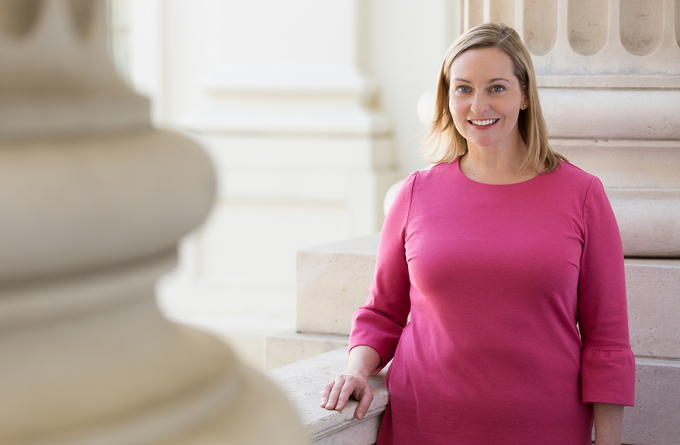 Photograph of Parker Hamilton Poling ’99 standing beside a marble column