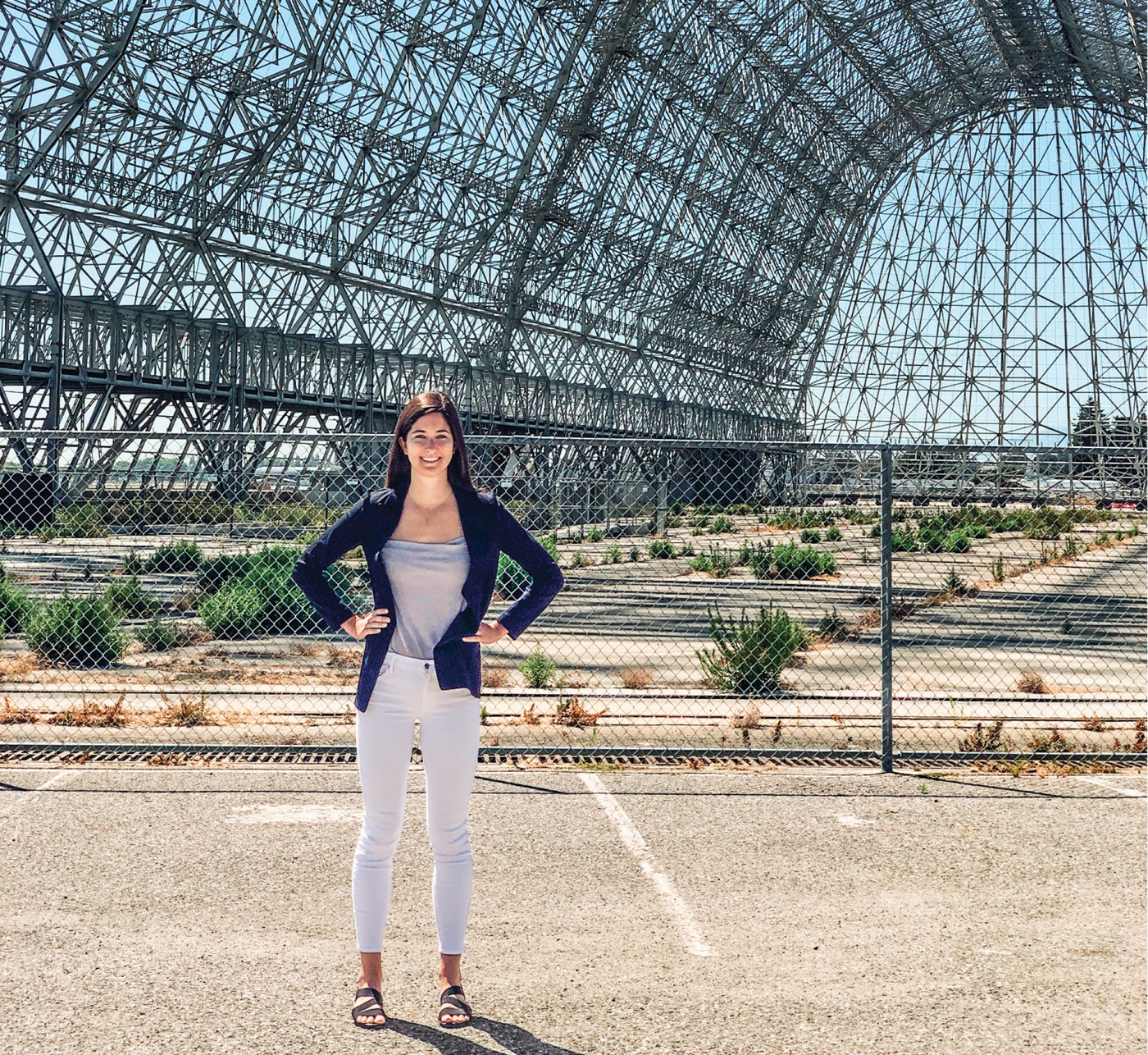 Ariel Deutsch standing outside an old NASA hangar