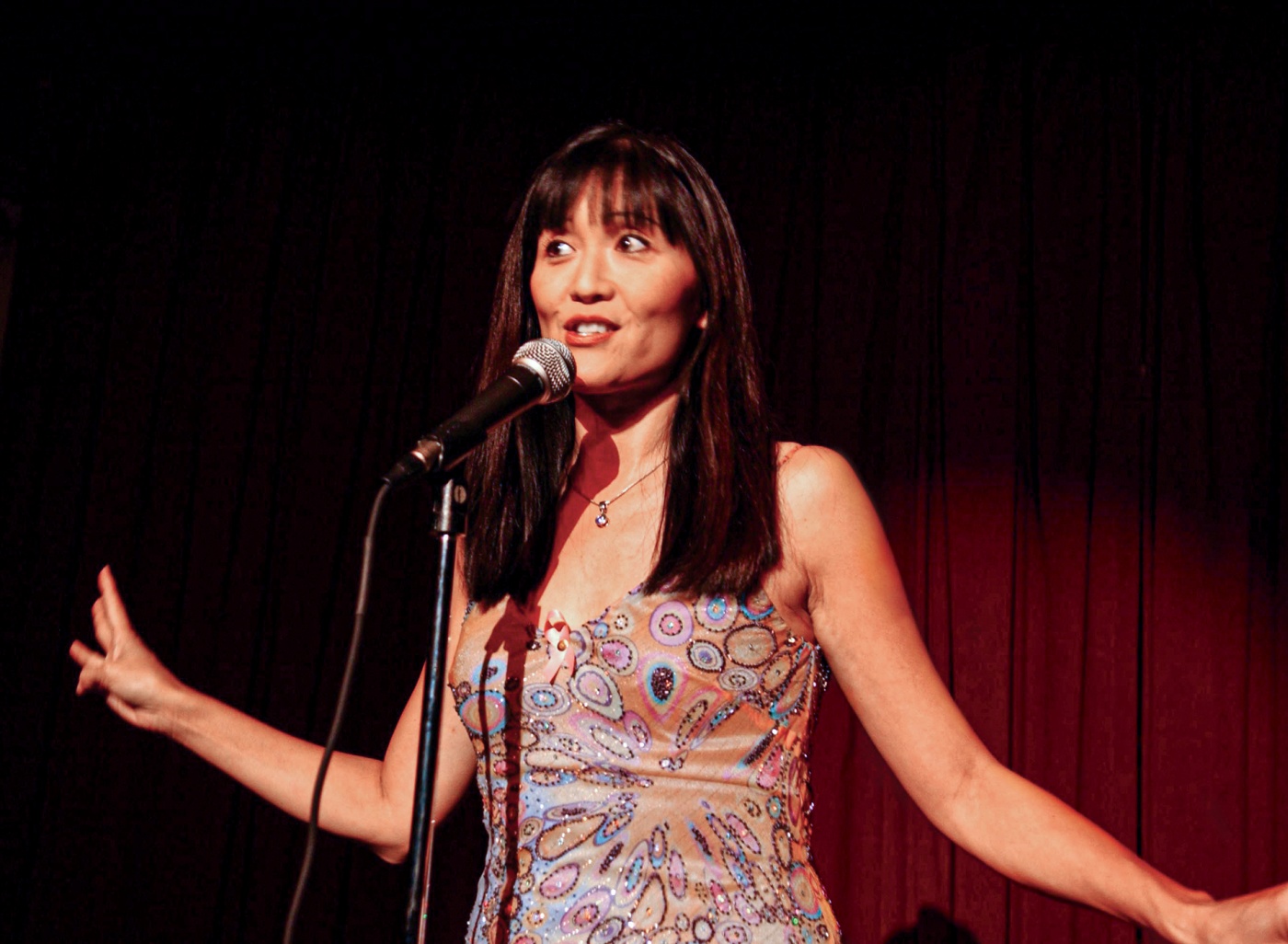 Suzanne Whang ’86 ScM photo doing standup comedy