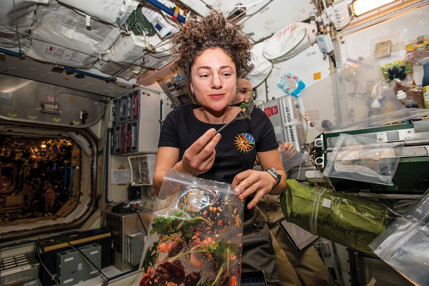 Meir dines on fresh ISS-grown mustard greens