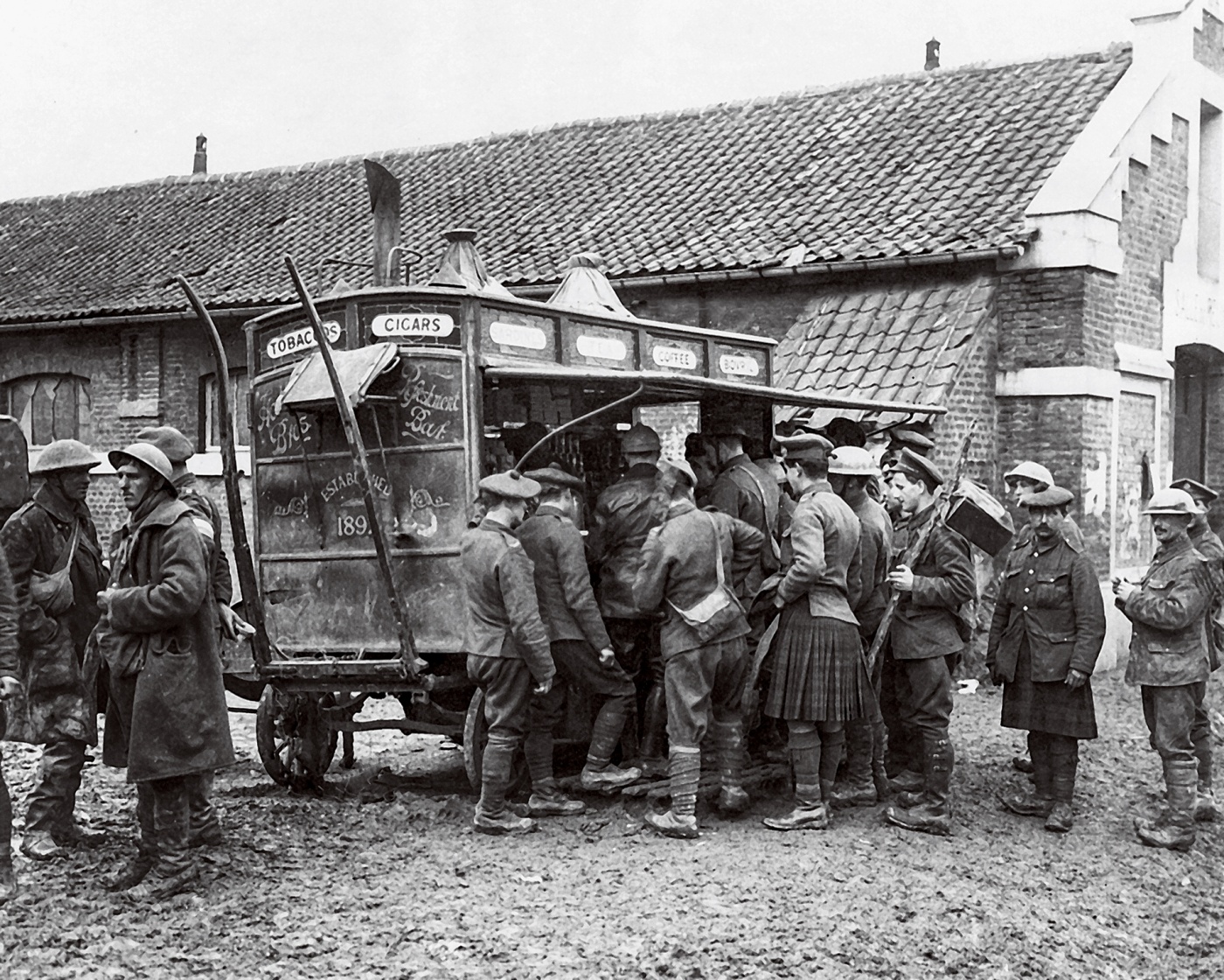 Soldiers gather at a coffee and cigarettes wagon