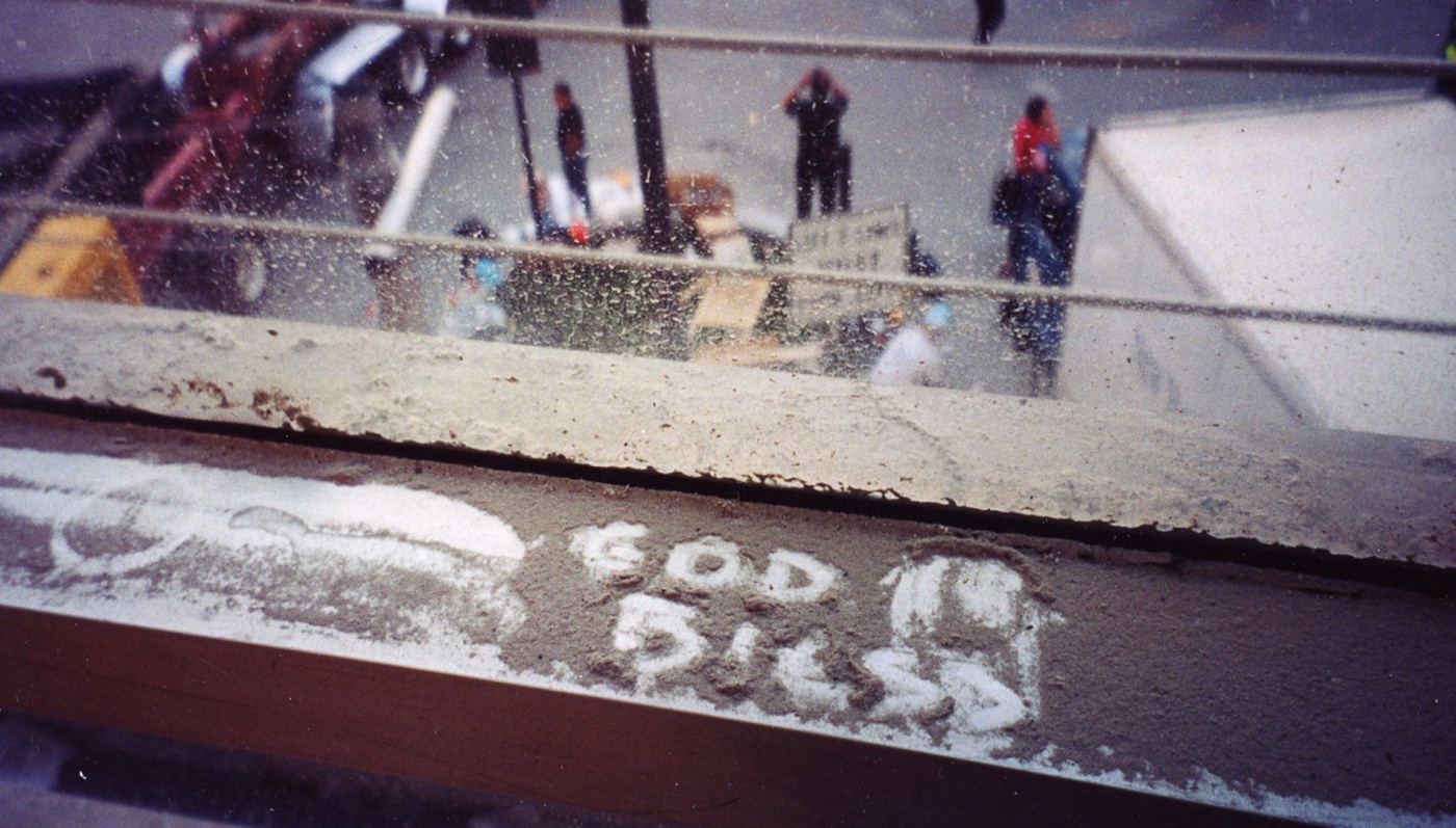 Image of the words "God Bless" written in ash during 9/11