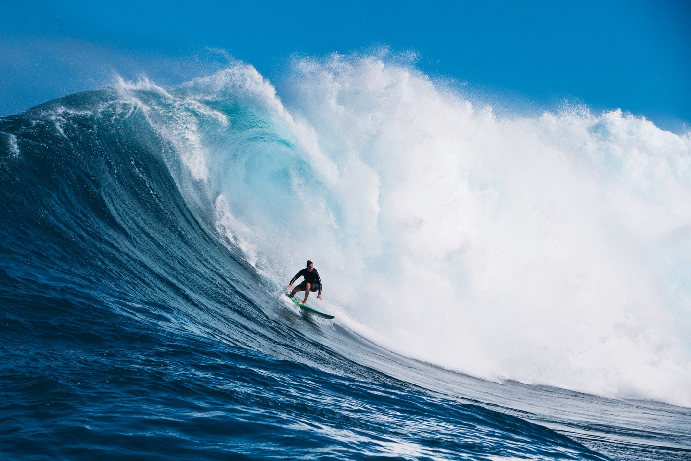 Paige Alms surfing in Maui