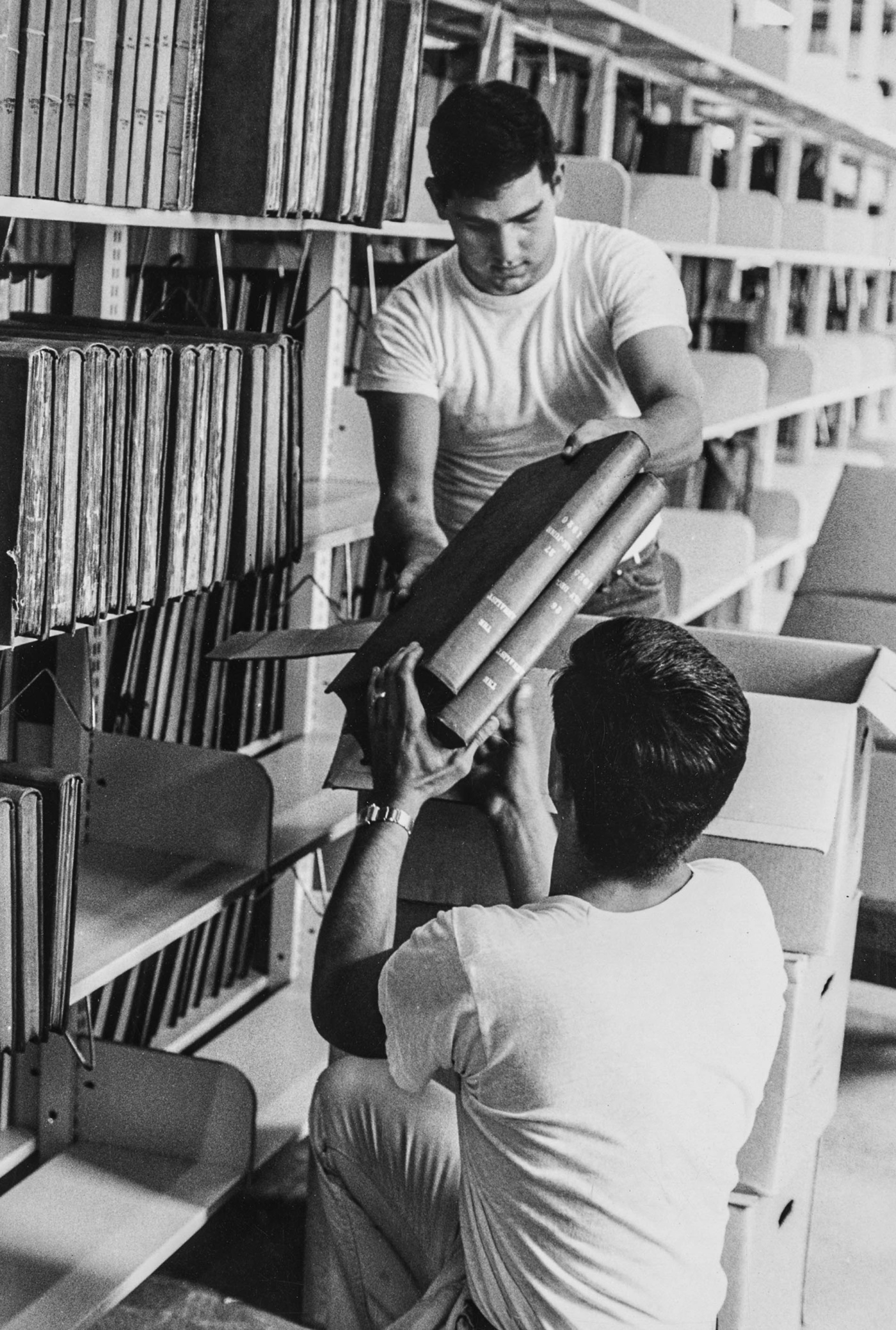Image of two students unpacking books at the Rockefeller Library at Brown