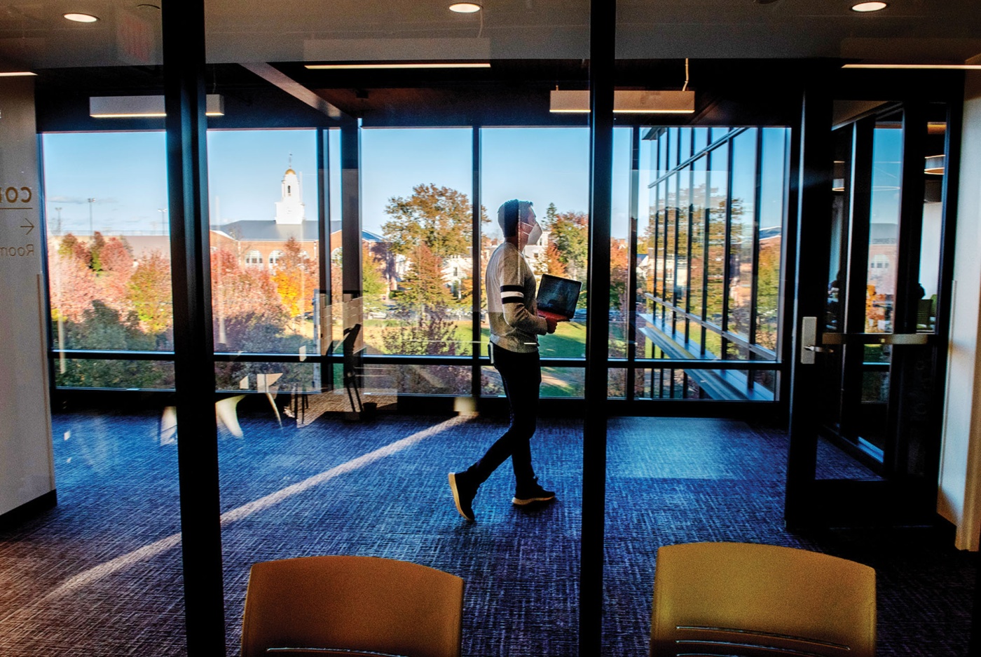Image of a student walking through Sternlicht Commons and Brown University Health & Wellness Center