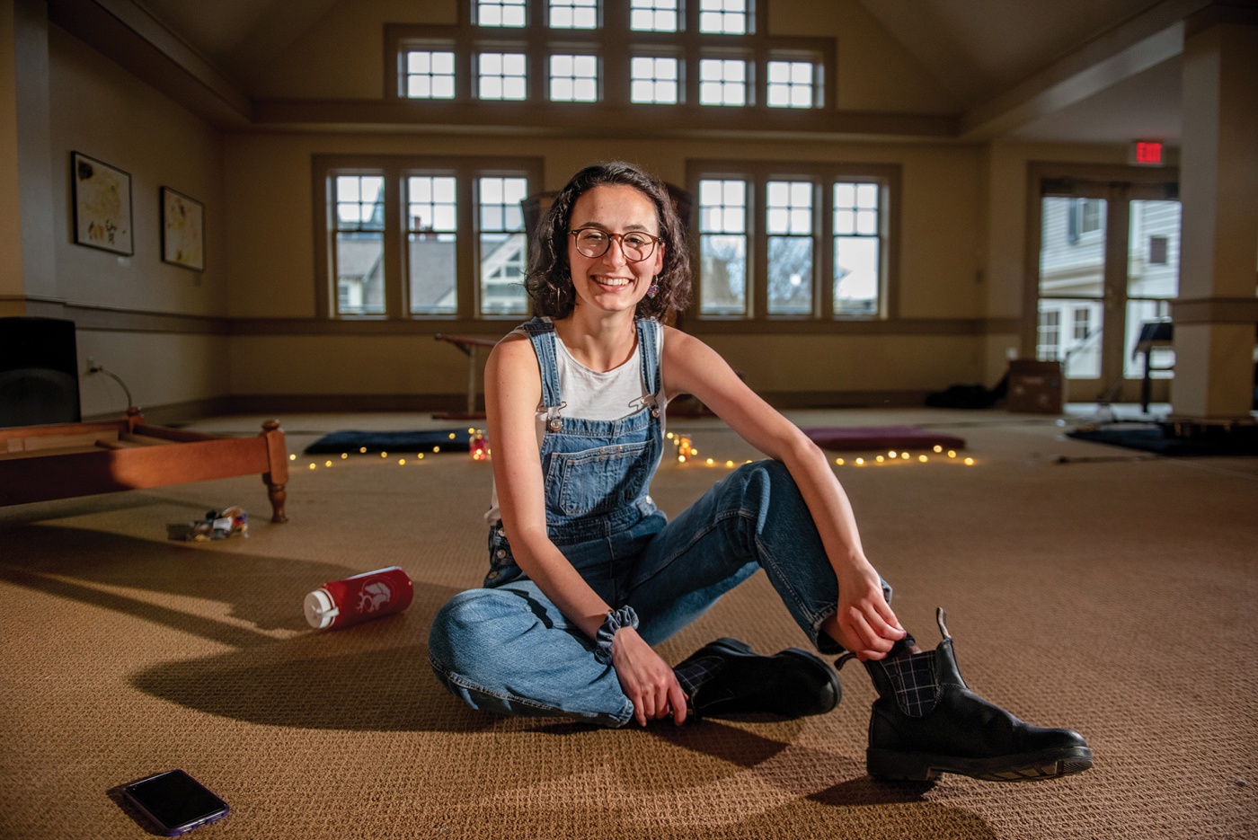 Image of Kaitlin Goldin sitting on the floor in the chapel at Hillel, Brown University