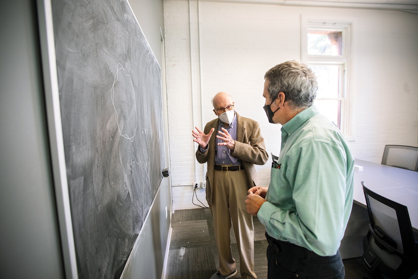 Manfred Steiner, now 90, works on a problem at the Barus and Holley Building with Professor of Physics Brad Marston.