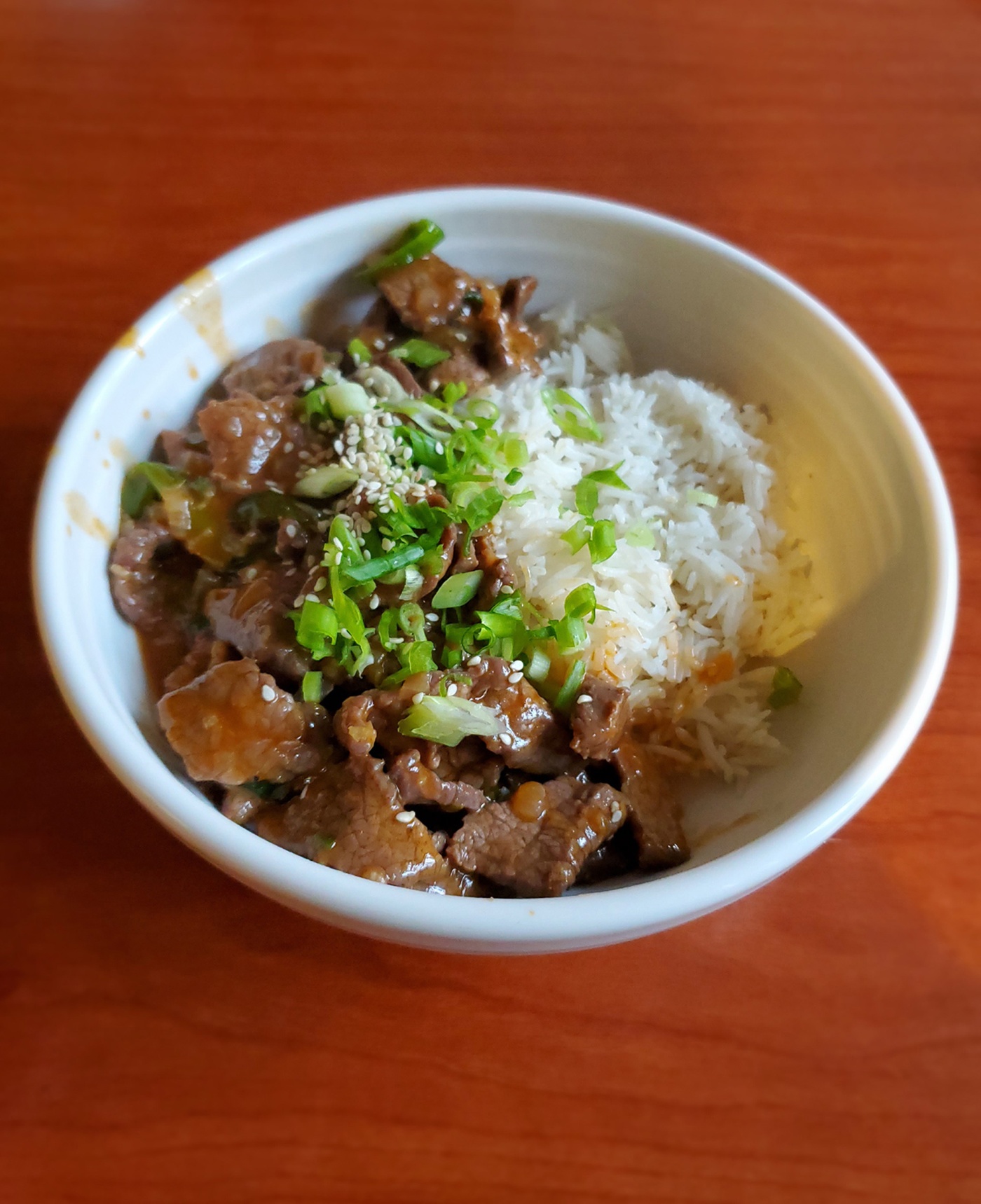 Bowl of stir-fried beef with jasmine rice. 