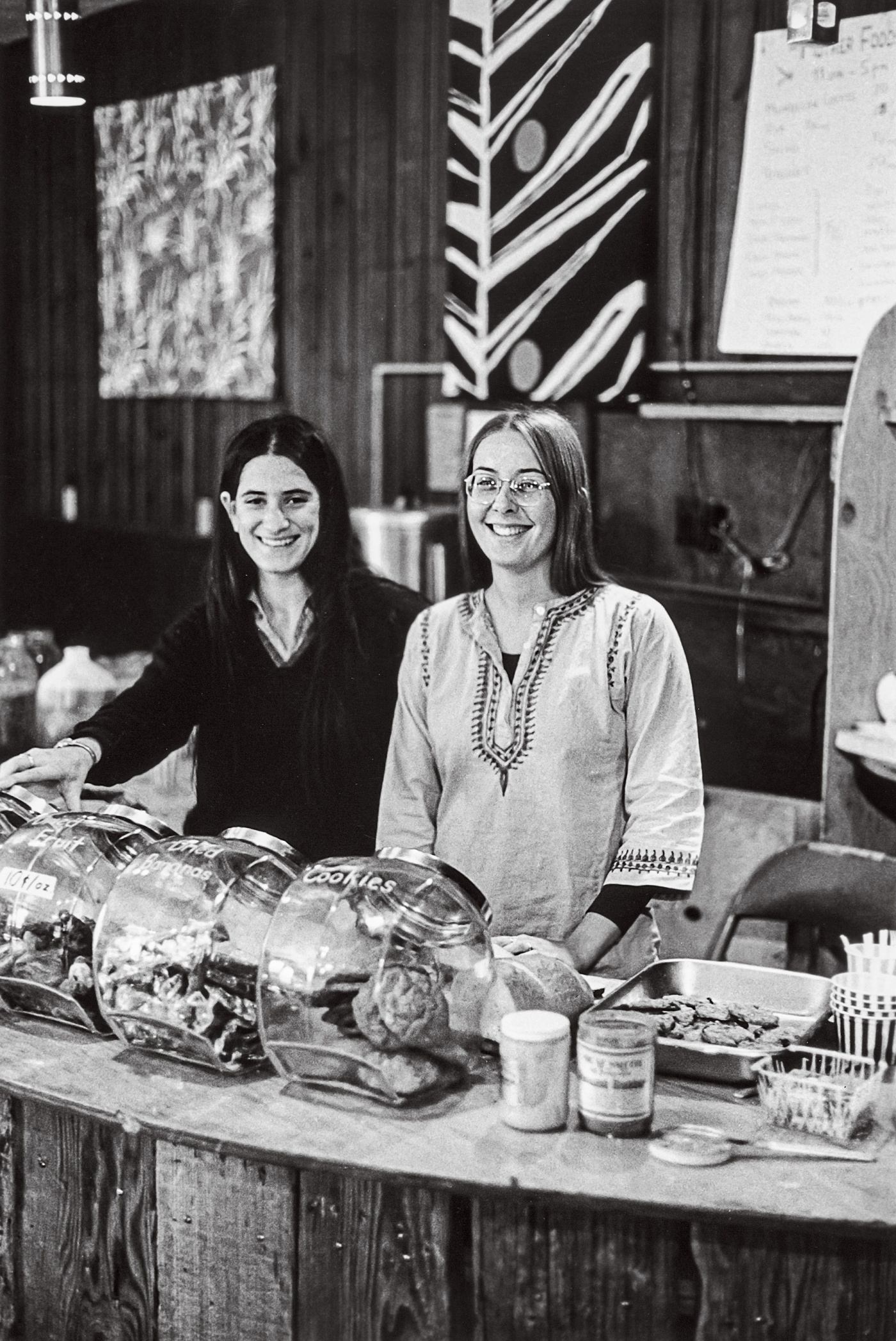 “Ahh! That Muenster on delicious pumpernickel!” remembers Marsha Jones ’76. Leslie Seeman ’73, left, pictured with Barb Goldman ’74, says they weighed the cheese to price it.  Neil Ward ’76 sold his whole wheat raisin “NeilBread” to the student-run coffeehouse, where you could buy vinyl from Mother Records and hear live acoustic music at night. “Lots of bell bottoms, floral shirts and flowing skirts, fringed jackets and love beads!” says Tony Affigne ’76, ’91 AM, ’92 PhD. “The atmosphere at Big Mother was e