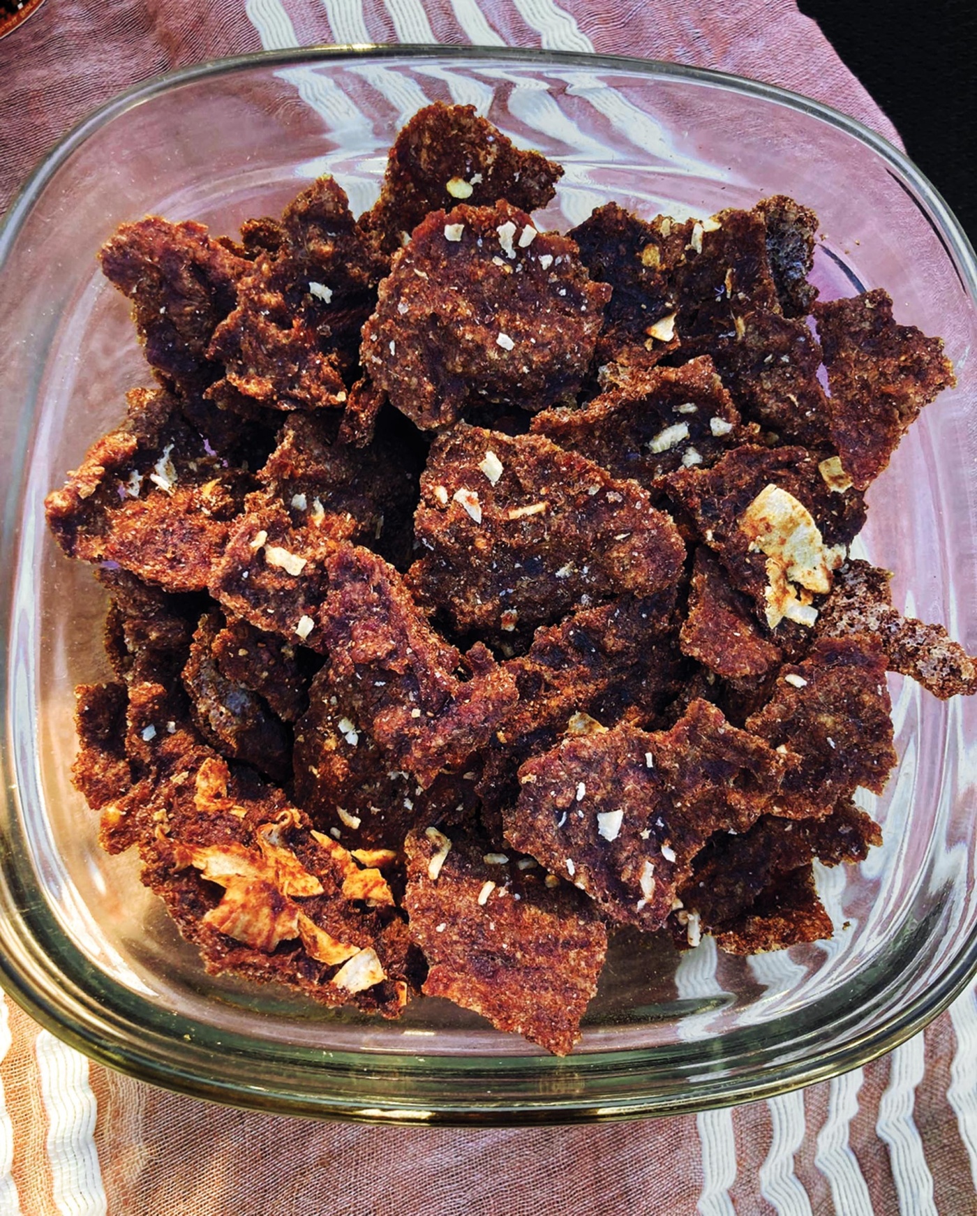 Image of teff in a glass bowl on a purple tea tablecloth