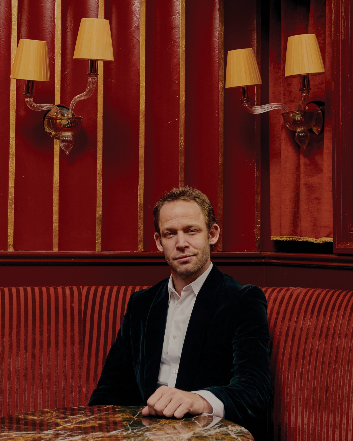 Image of Neidich sitting in a booth at his restaurant