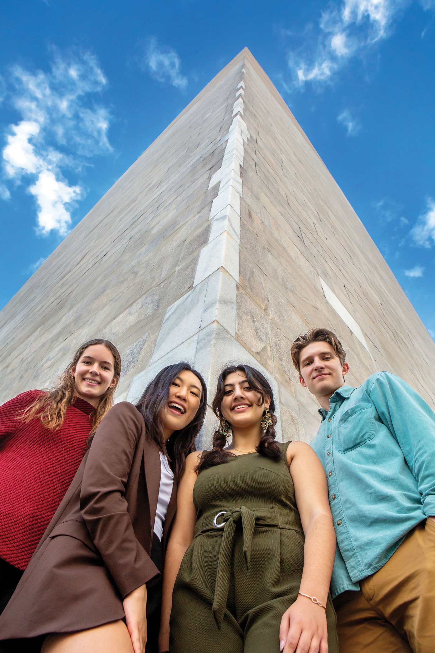Image of Isabelle Sharon ’23.5, Alice  Im ’24, Ruhma Khawaja ’24, and author Peder Schaefer ’22.5 at the base of the Washington Monument.