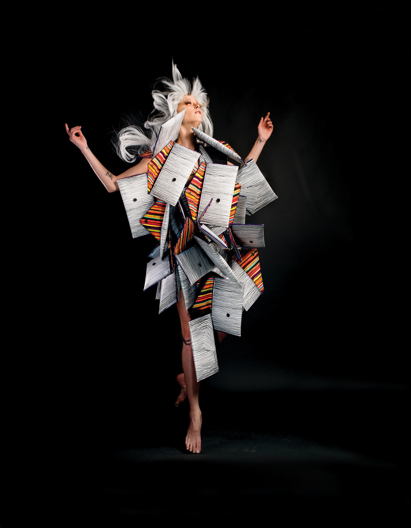 Image of a model surrounded by Kent Stetson's handbags in the shape of a moth.