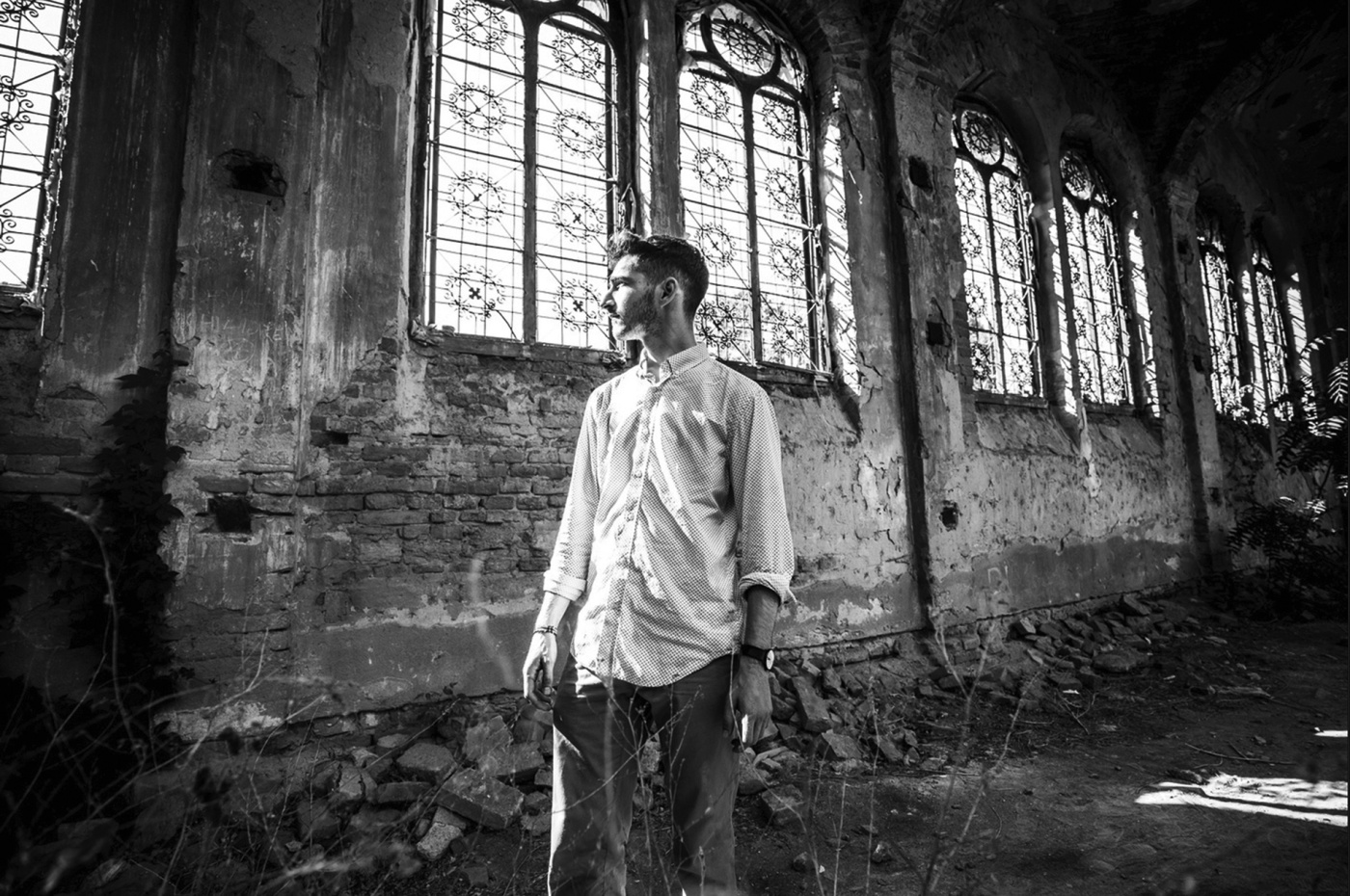 Black and white image of Jonah Blumenthal in a rundown building.