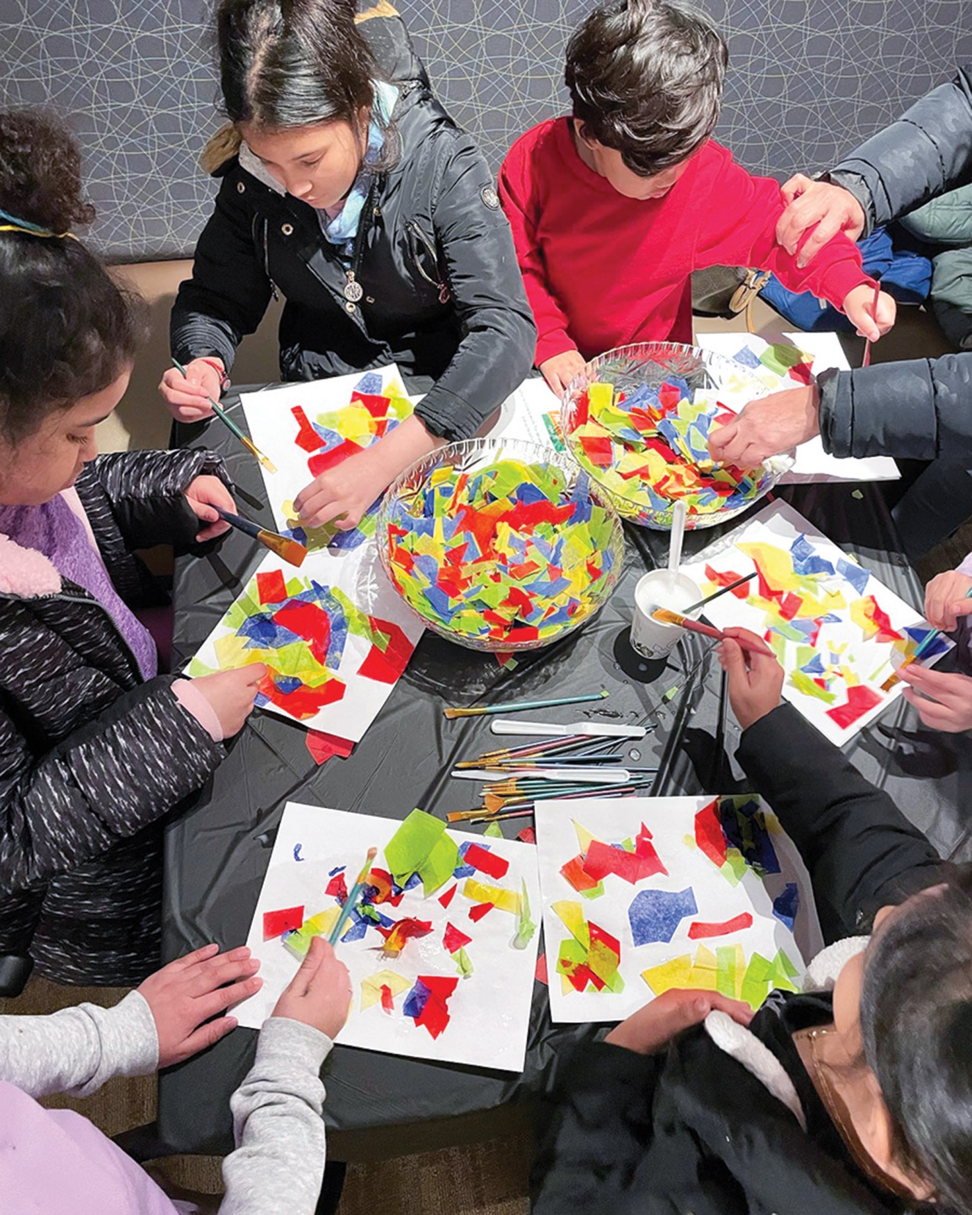 Image of kids sitting around a table doing an art project