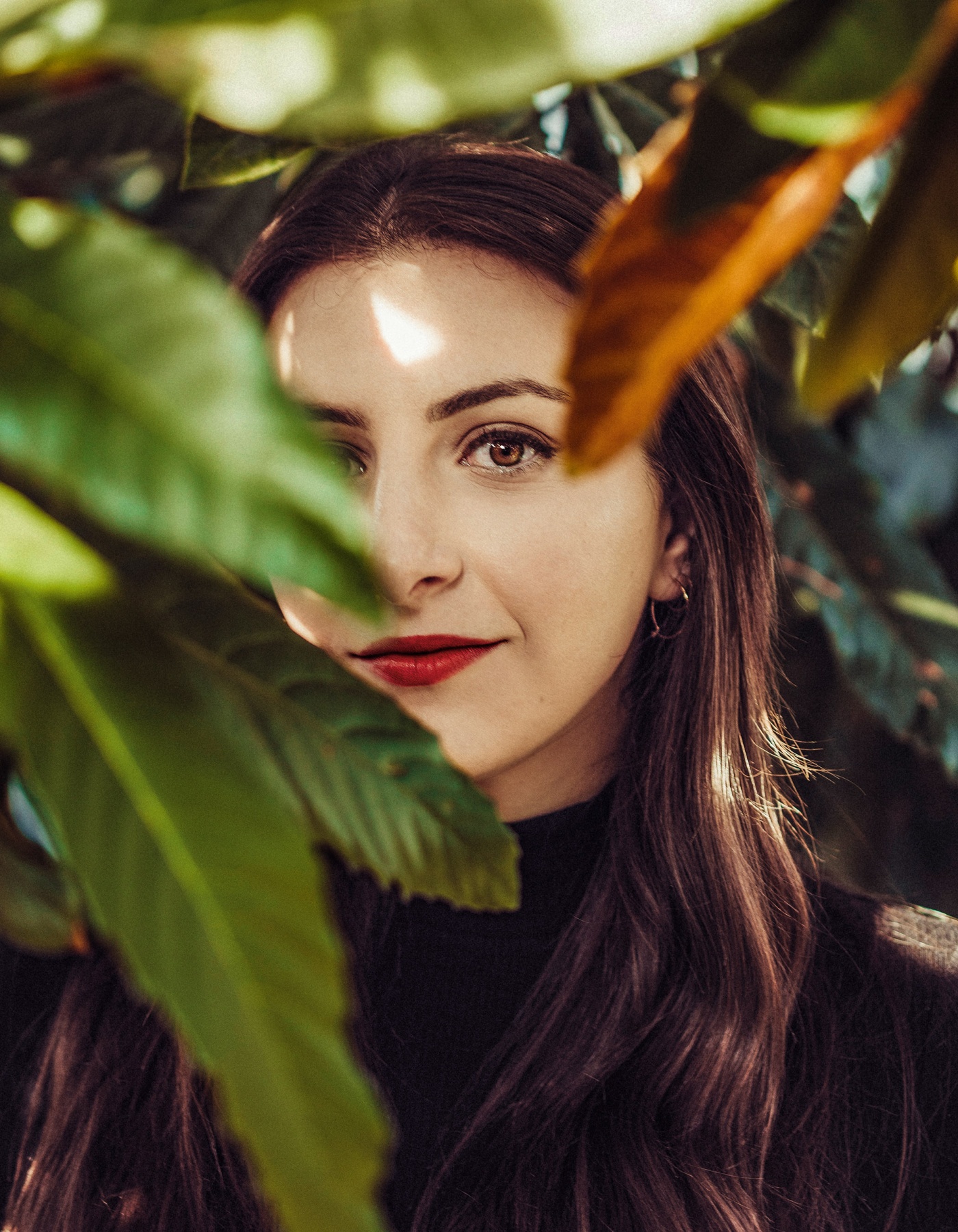 Image of Dana Schwartz looking through some plants