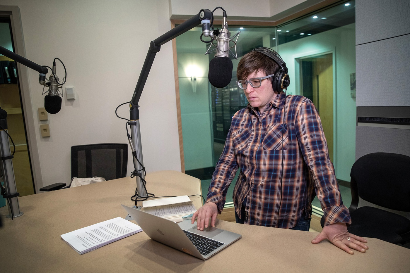 Image of Beth Schwartzapfel in front of a mic with her computer.