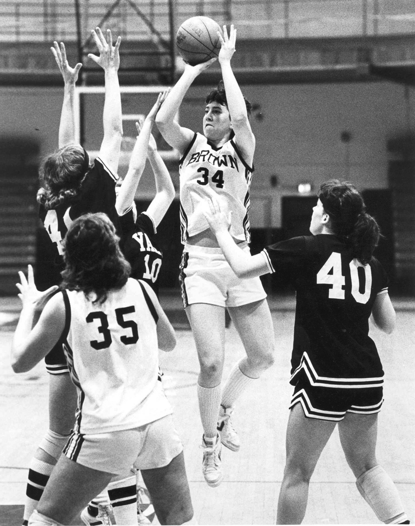 Black and white image of Christa Champion shooting the basketball in a Brown game in 1984.