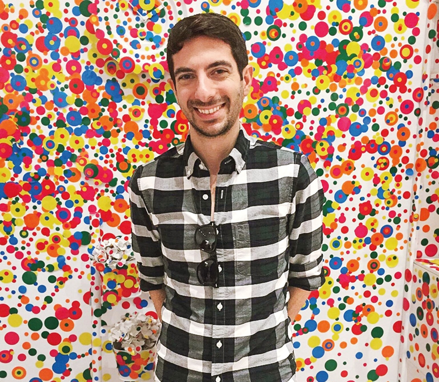 Image of David Pagliaccio standing in front of a colorful wall. 
