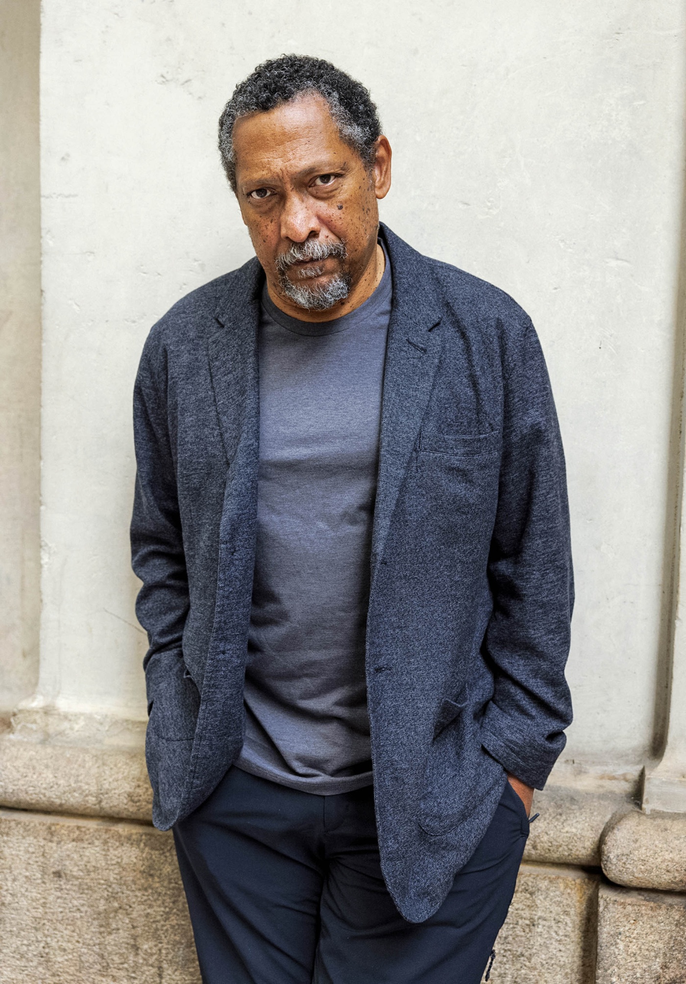 Image of Percival Everett leaning against a white wall